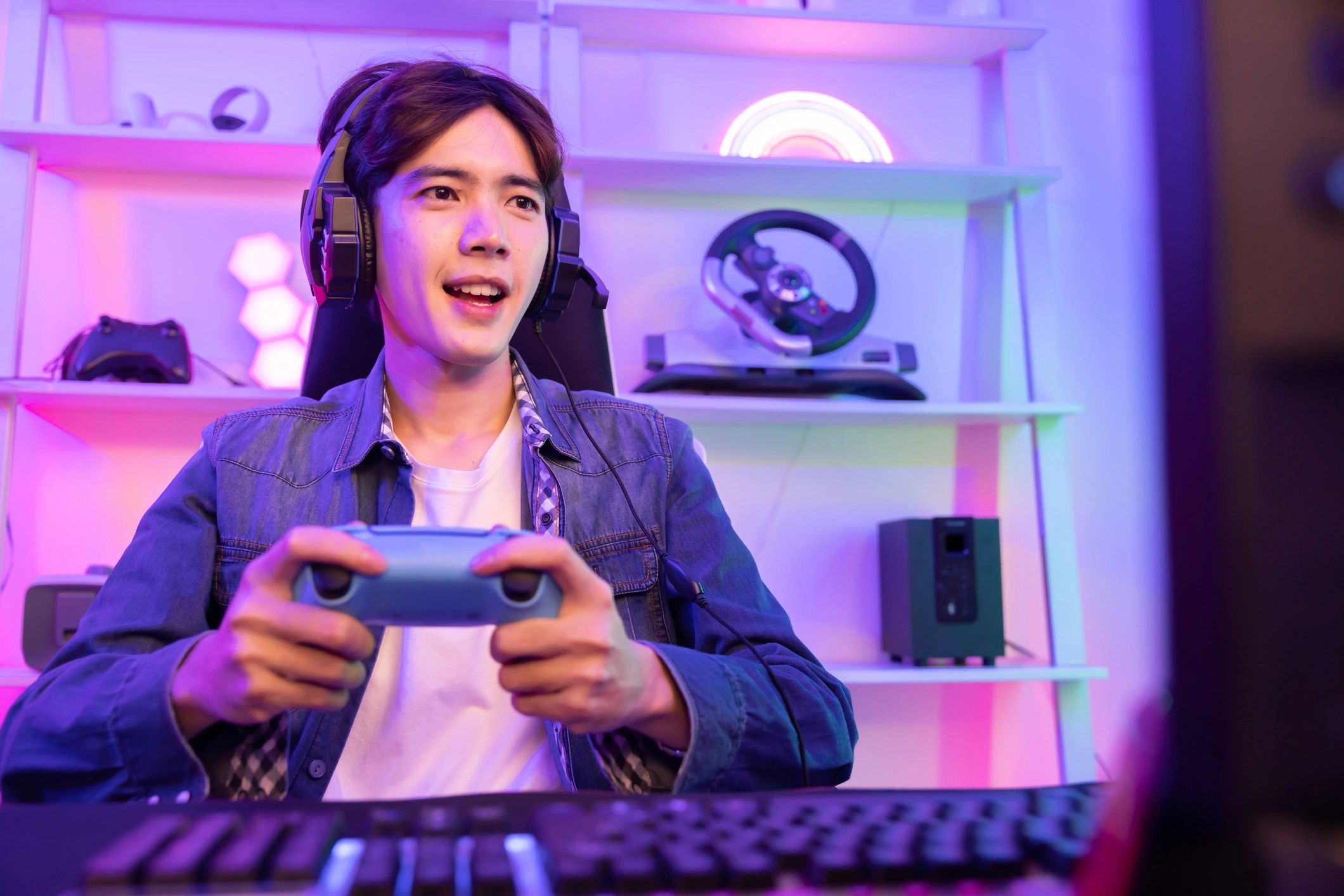 Male Gamer Playing Console Game with Game Controller